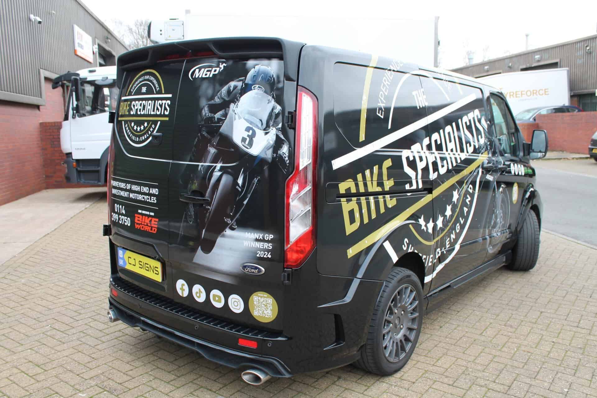The Bike Specialists van wrapping with black, white and gold branding